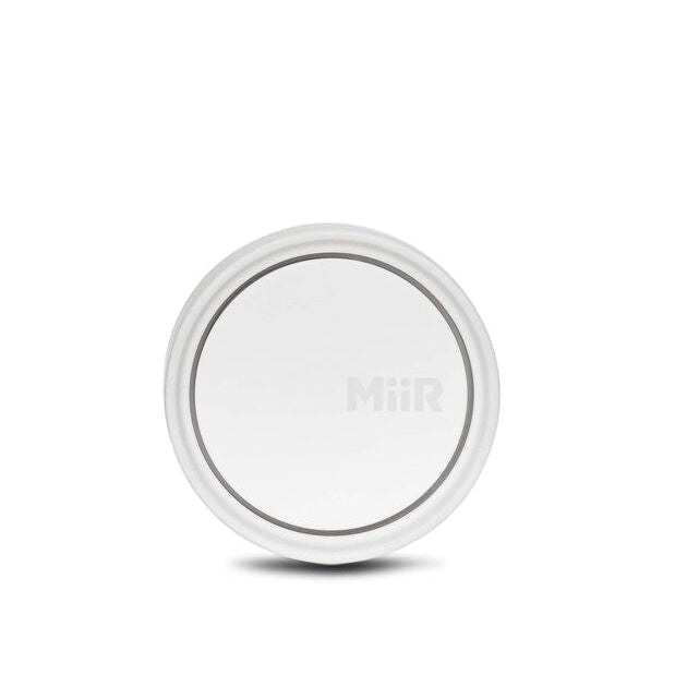 White wireless charging pad on a white background